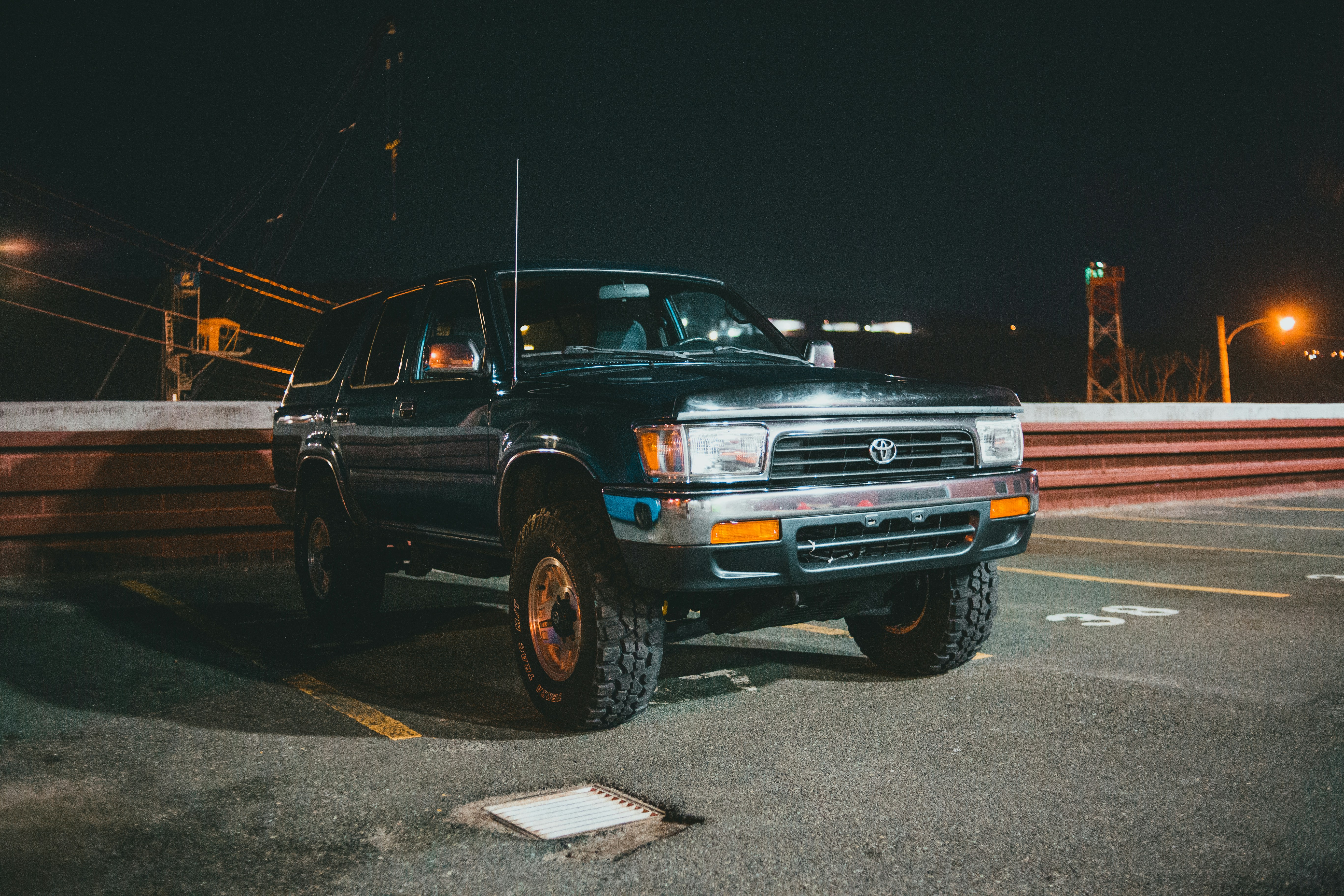 Black SUV with amber marker lights photographed at night