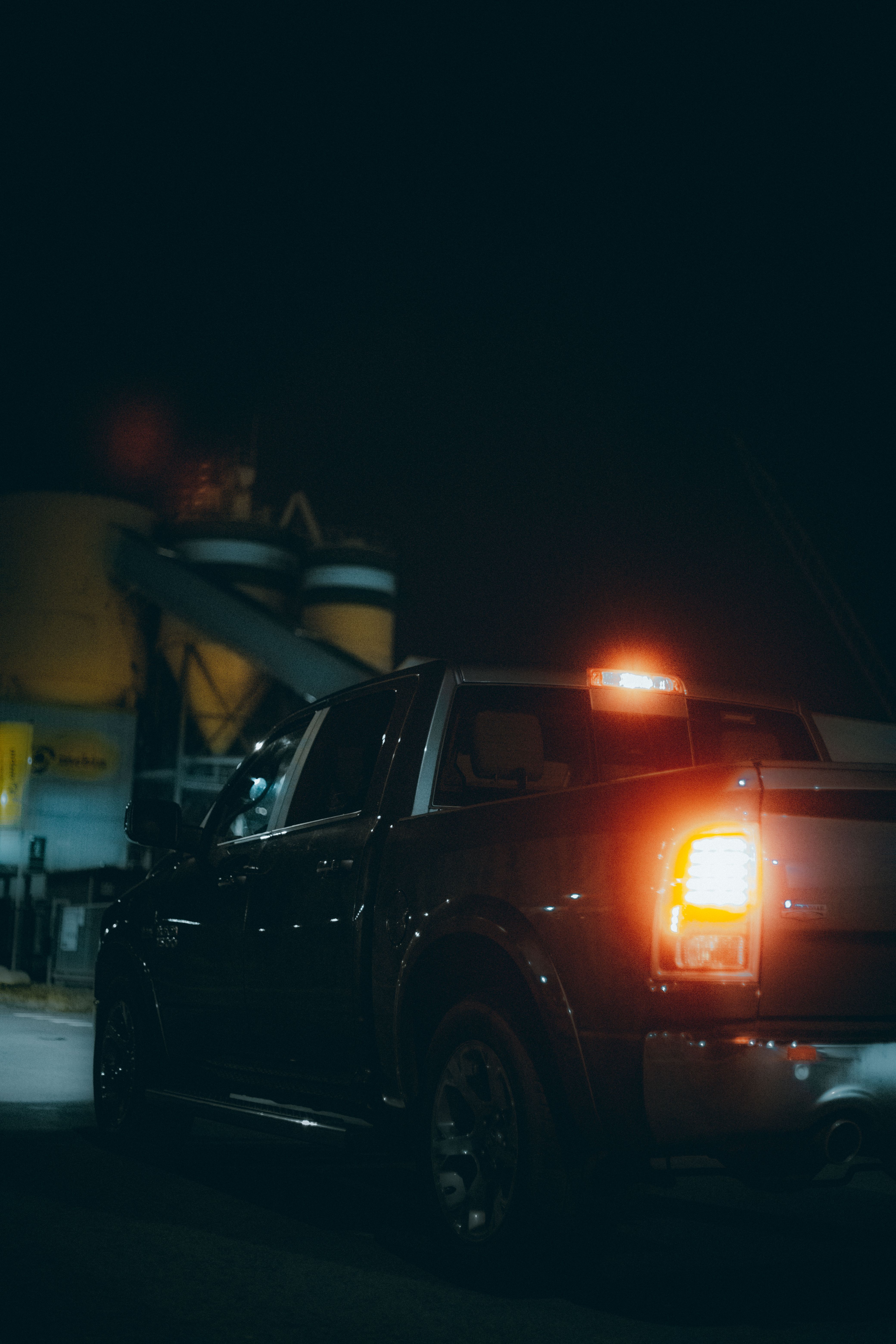 Pickup truck with rear lights illuminated after dark